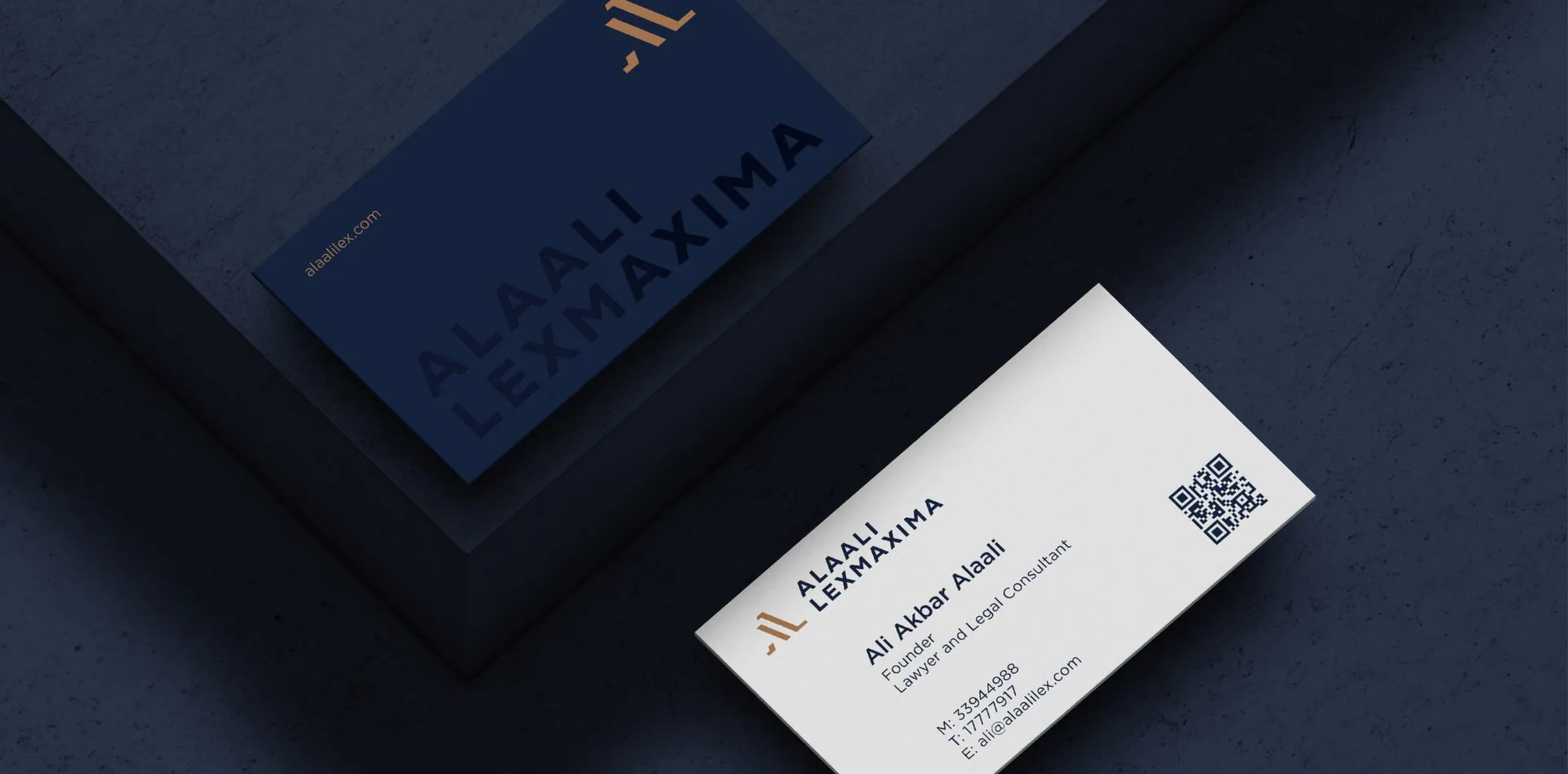 Alaali LexMaxima business cards in navy and white with copper details, on a dark navy surface
