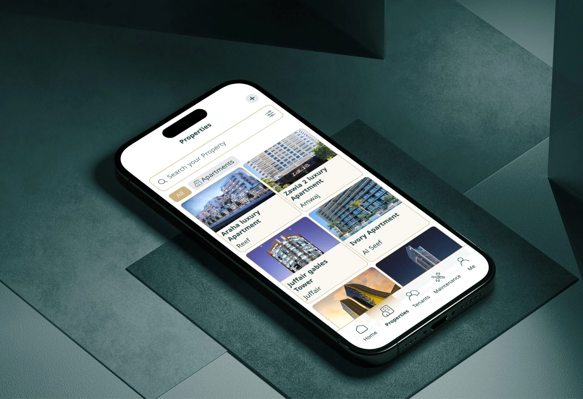 iPhone showing the Mullak+ property listings app, lying on layered teal paper